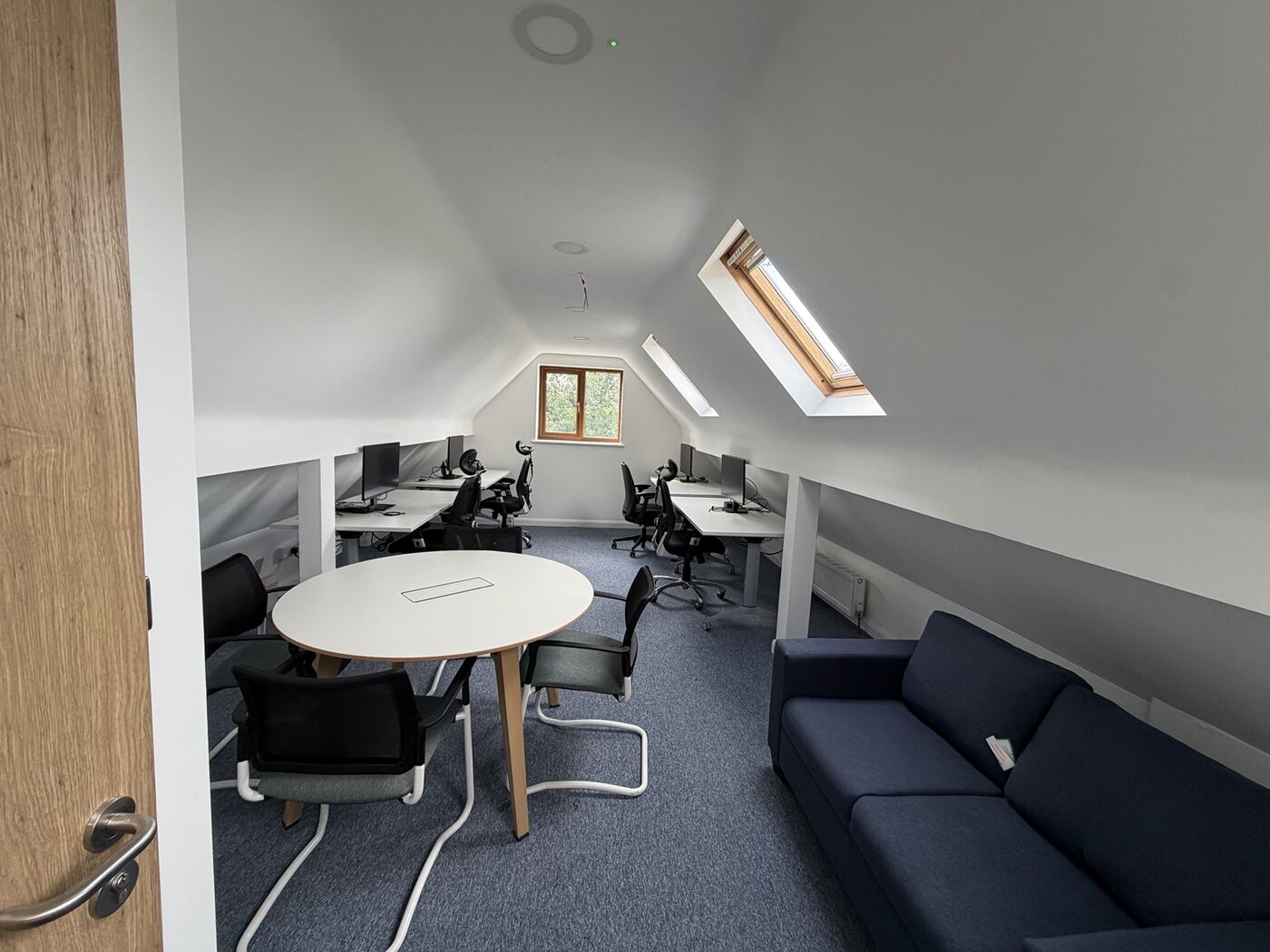 Second-floor staff office with desks under the roof slope
