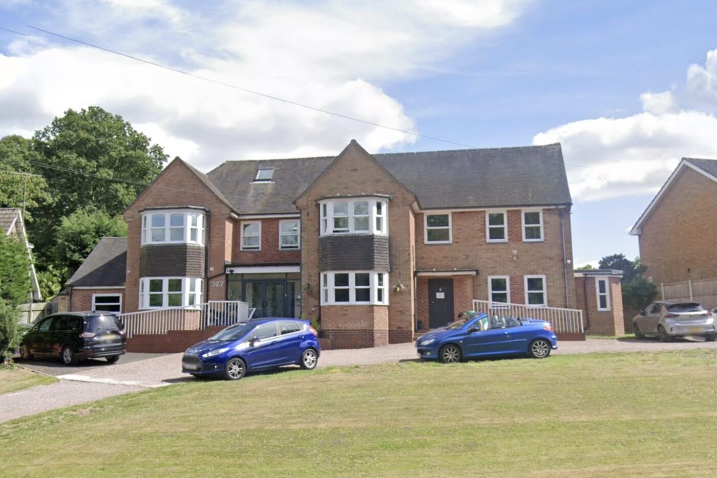 Haversham House, Redditch: a large two-storey brick house with twin gabled bays
